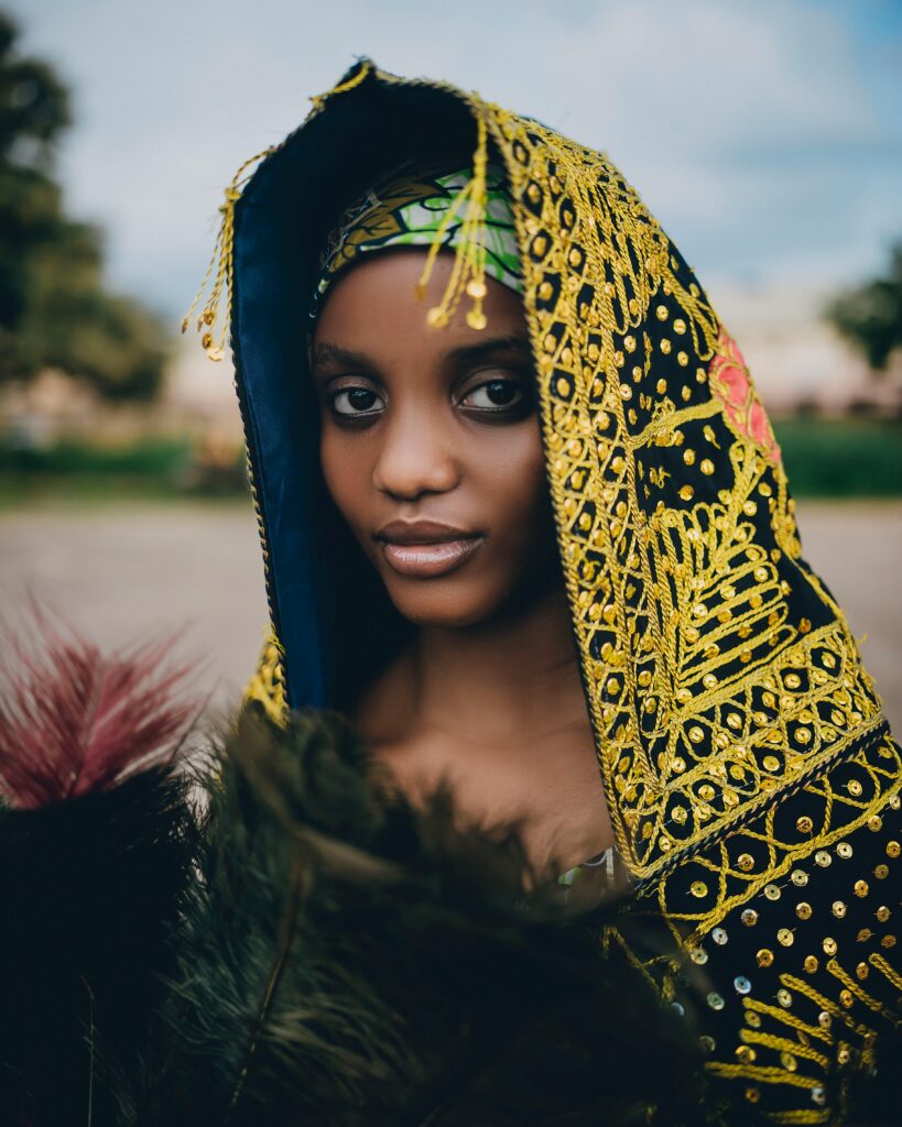 Stunning portrait of a woman wearing traditional African clothing outdoors.